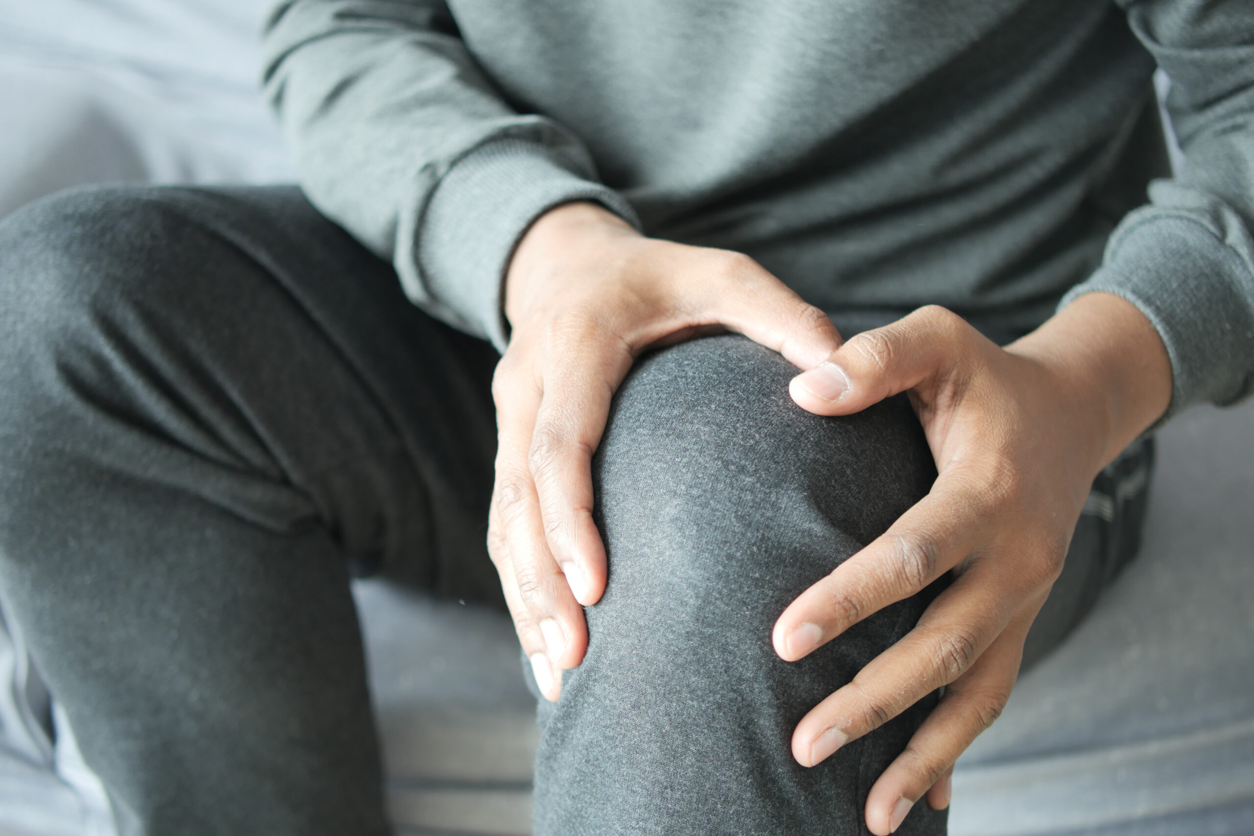 Close up on man suffering knee joint pain